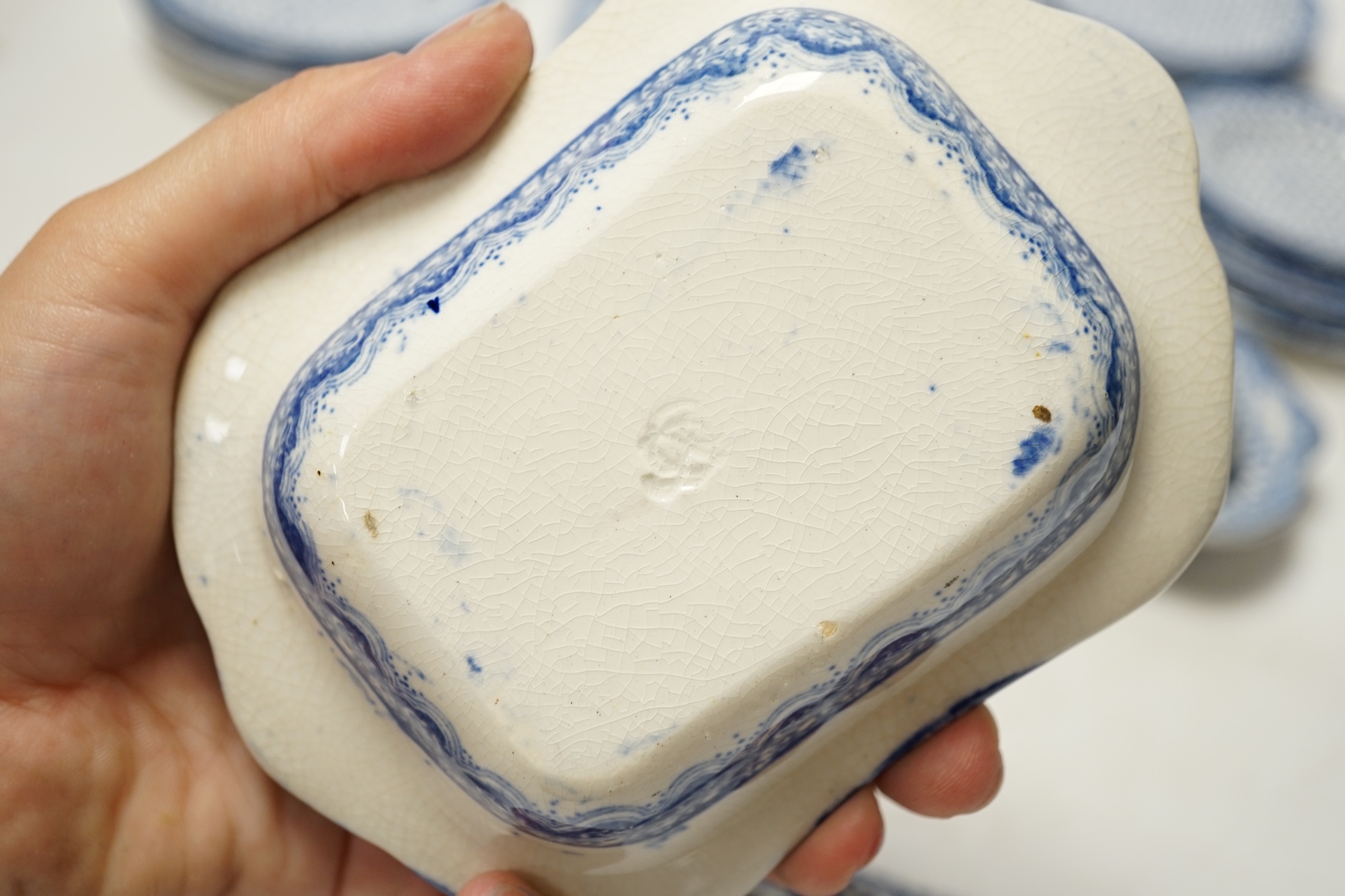 A 19th century blue and white child's twenty piece dinner service, tallest tureen 9cm high. Condition - cover on smaller tureen and soup dish cracked, manufacturing faults on the transfer printed decoration